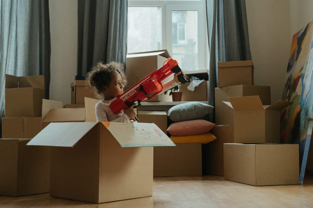 child moving home with boxes