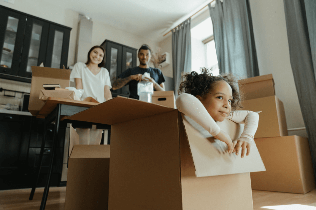 Couple packing for moving with kids